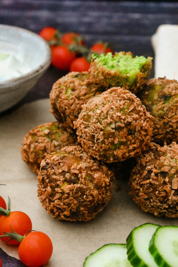 Crisp green falafel made with edamame beans, peas and coriander and served with a yoghurt, cucumber and mint dip. This recipe is easy to make at home and suitable for vegetarians or vegans.