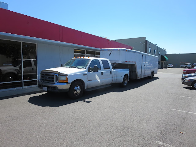 Trailer arrives to transport shell to race shop for driveline & suspension installation.
