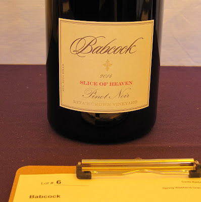 Bottle of pinot noir, Slice of Heaven, on auction table at SB Vintners Festival