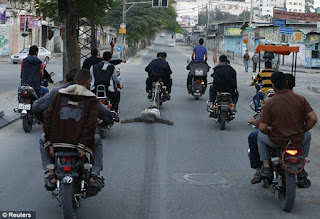 Palestinians drag body of suspected spy behind motorcycles in Gaza Palestinians drag body of suspected spy behind motorcycles in Gaza