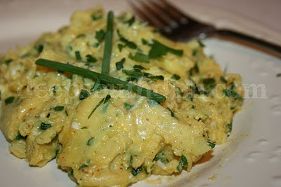 Scrambled eggs, cooked to a creamy perfection with butter and heavy cream and by constant and gentle stirring, tossed at the end with fresh flat leaf parsley and chives.