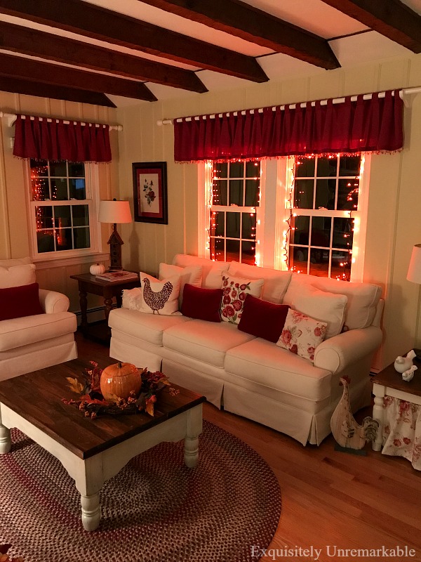 Fall Cottage Style Decor For Halloween In the living room with orange mini string lights in windows