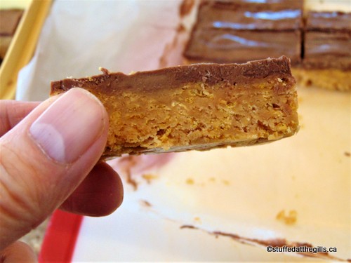 Peanut Butter Cereal Bar held in the author's hand, ready to be eaten.