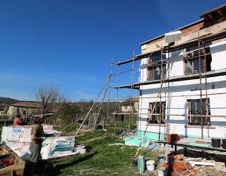 Using a pulley to get materials up the scaffold Using a pulley to get materials up the scaffold
