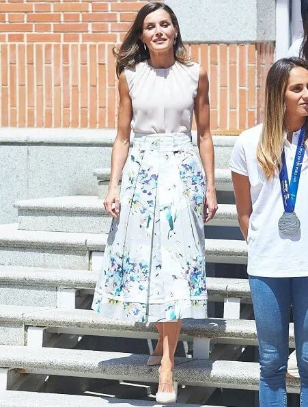 Queen Letizia wore Adolfo Dominguez floral print dress. She wore Hugo Boss silk blouse. 2020 Tokyo Olympics