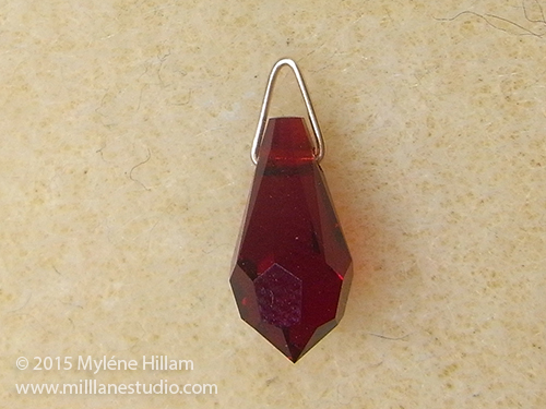 Red teardrop bead on a triangle jump ring