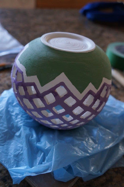 Pierced clay ceramic candle holder vessel in progress.