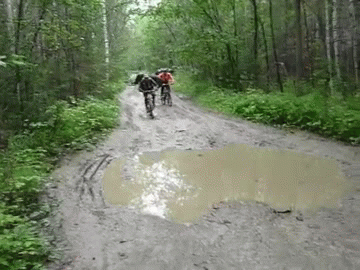 Radtour nach Regen durch Pfütze fahren und hinfallen lustig