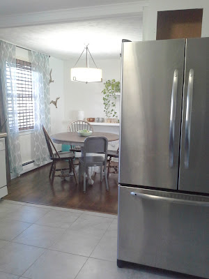 open kitchen dining room stainless steel refrigerator 
