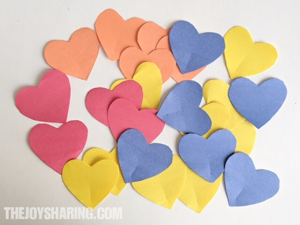 Cut out heart shapes to make paper heart flowers.