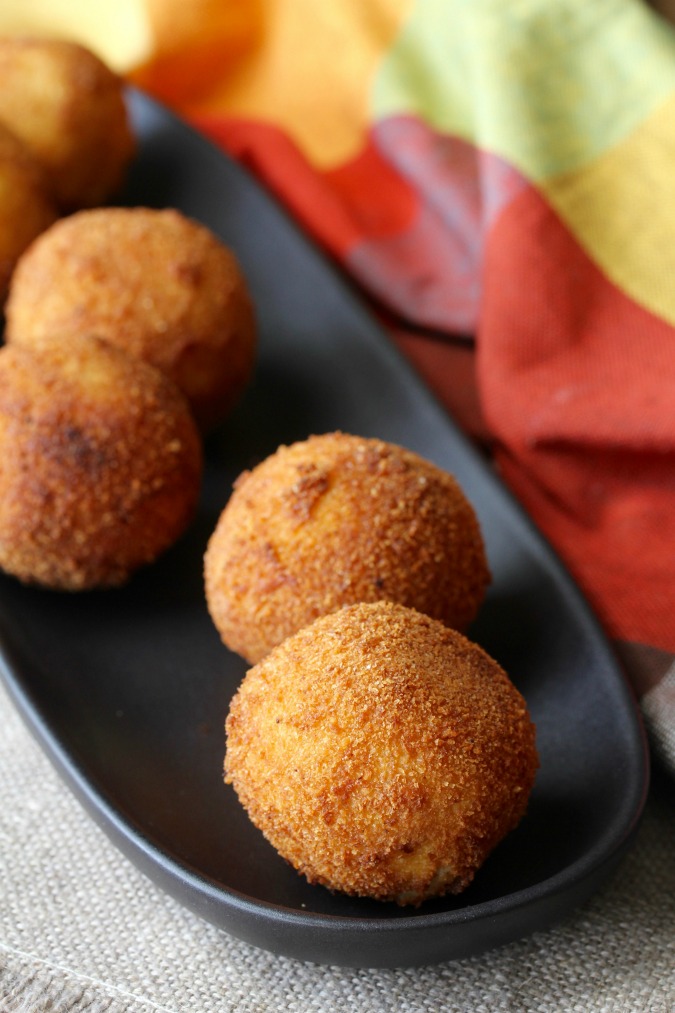 Cuban Papas Rellenas are mashed potatoes stuffed with seasoned meat, rolled into a ball, breaded, and then deep fried, resulting in these little packages of pop-able deliciousness.