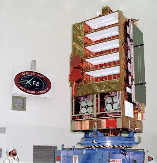 NASA's Rossi X-ray Timing Explorer satellite, shown here during prelaunch checks in 1995, was built to study the time variation of X-ray sources in space. Credit: NASA