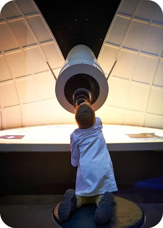 Small Boy stargazing at the National Space Centre Leicester