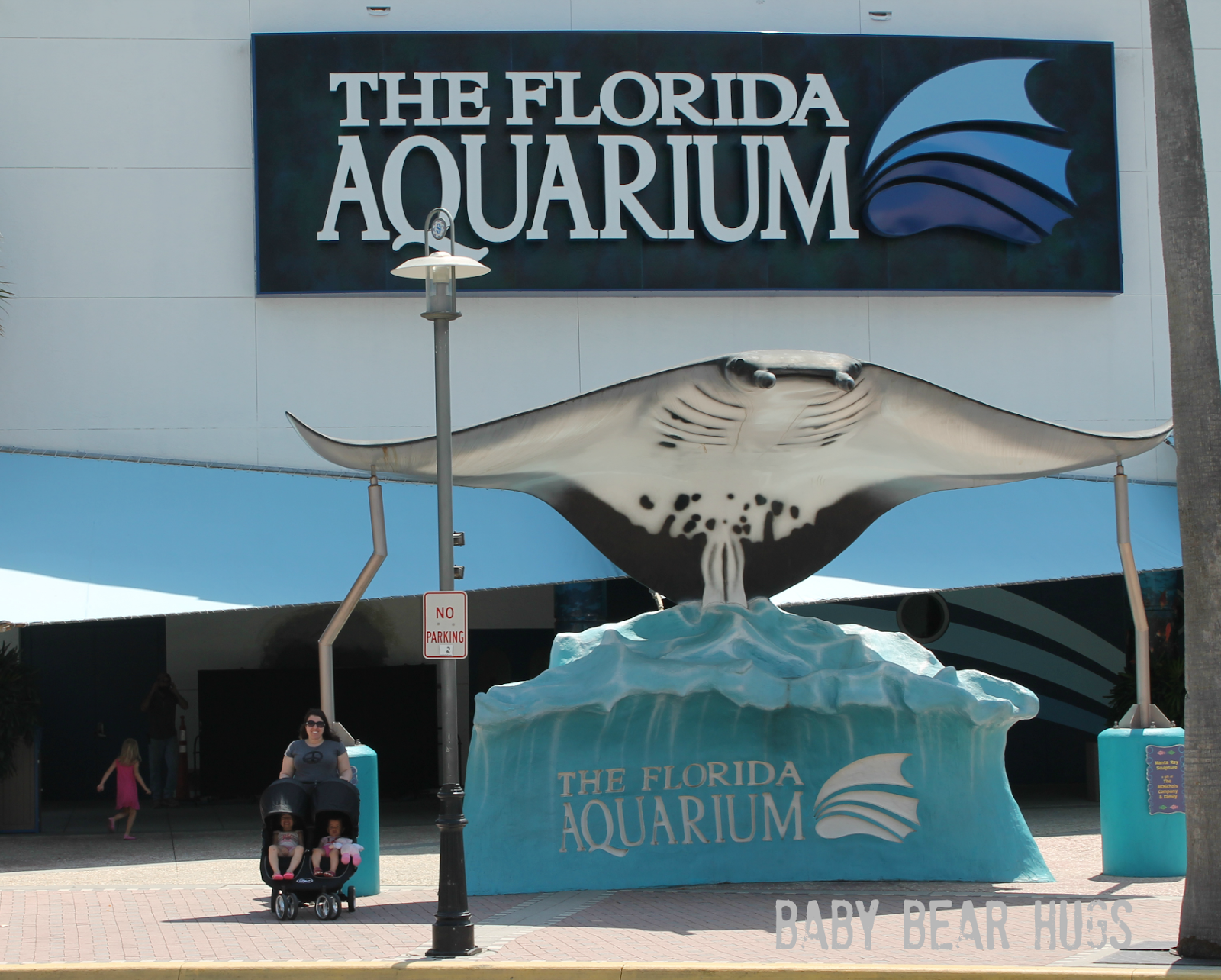 family in front of the florida aquarium with city mini double stroller