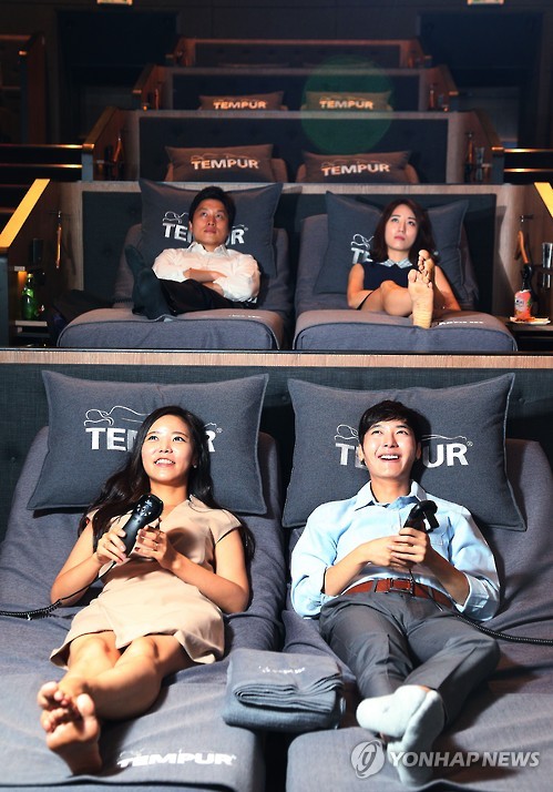 Parejas coreanas en un cinecama de Seúl