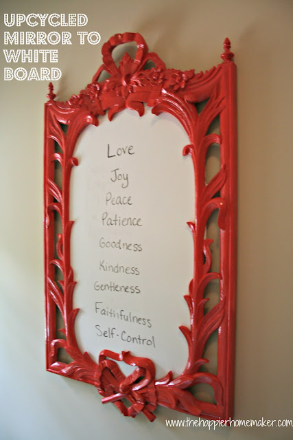 A close up of a red wood frame used as a dry erase border