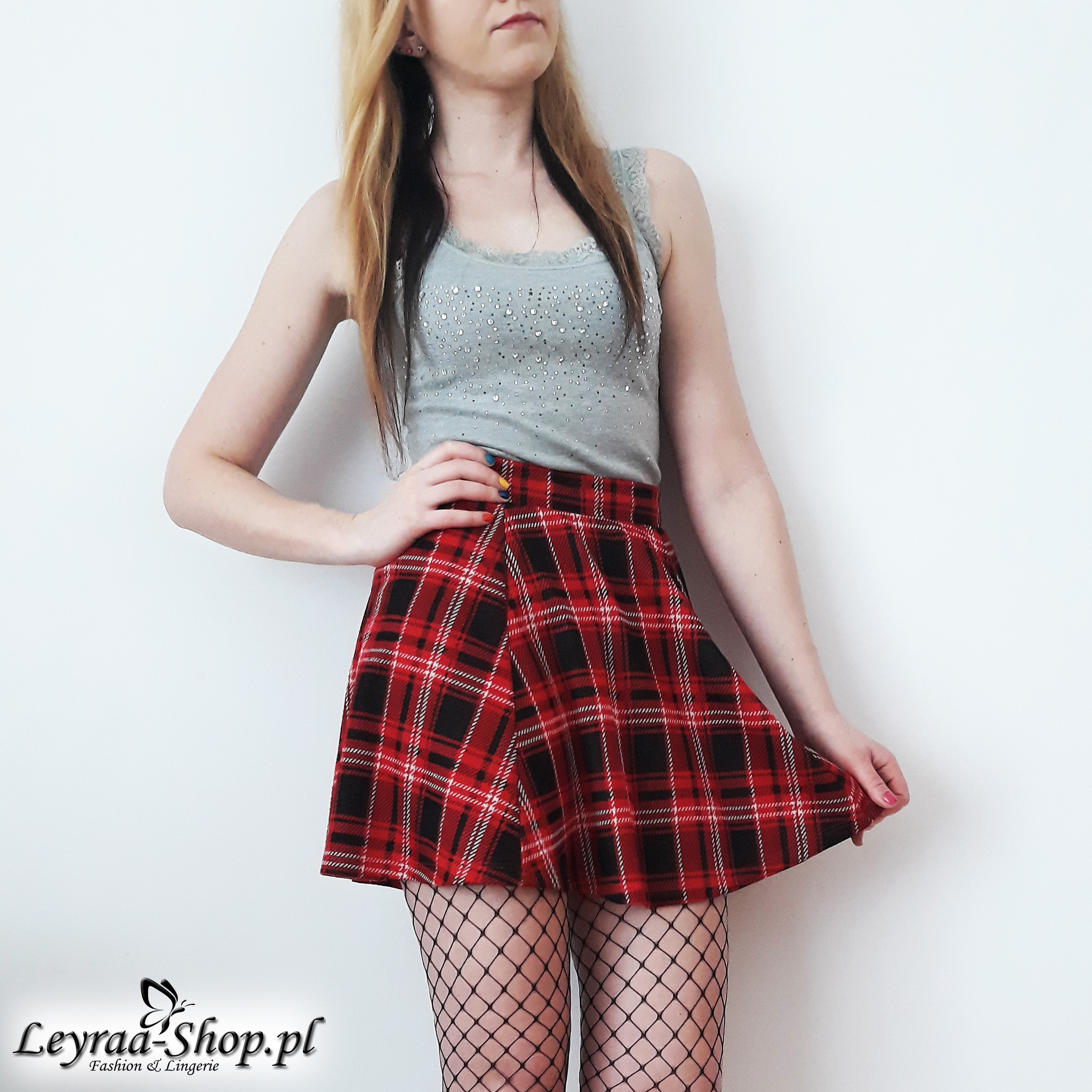 Fishnet tights, gray boxer shorts with rhinestones, flared red checkered skirt, black high heels