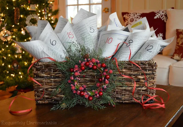 Stamped Newspaper Advent Calendar in a holiday basket in front of the tree