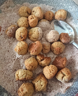 add the baked churro balls to the cinnamon mixture