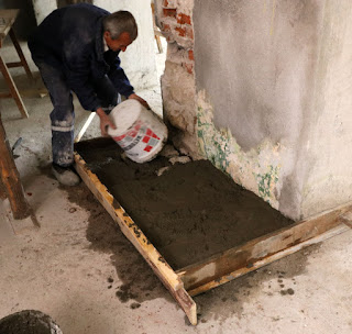 A bucket of concrete is added to the step A bucket of concrete is added to the step