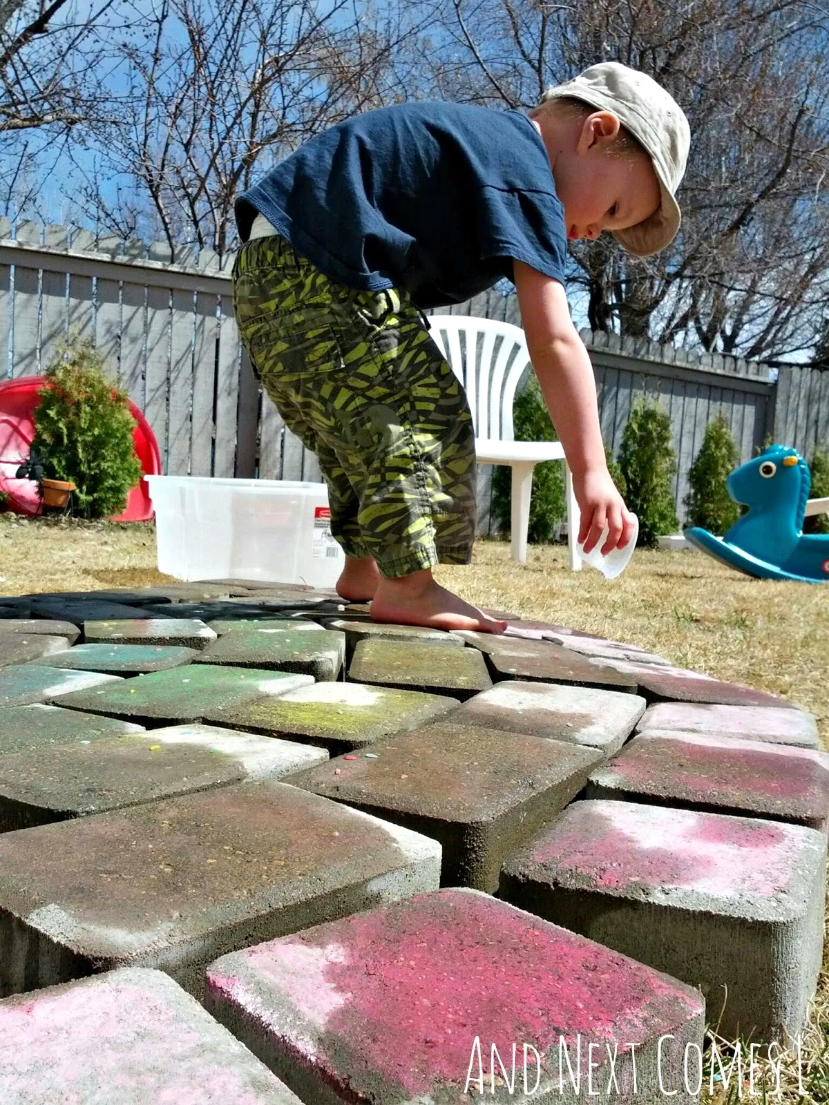 Water play for kids using a giant chalk rainbow from And Next Comes L