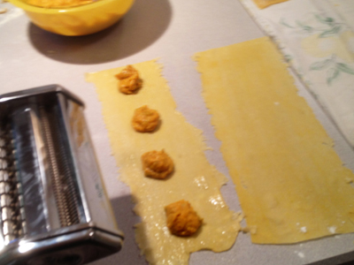 pumpkin filling is shown on one sheet of pasta, on top of egg wash.