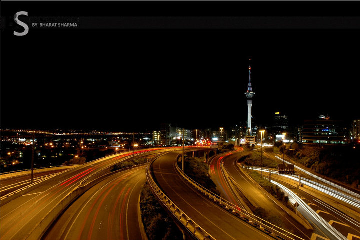 After some of the interesting PHOTO JOURNEYs by Bharat, here is another PHOTO JOURNEY from New Zealand. This time some sparkling Night photographs from Aukland Sky Tower and other places around the same. Let's check out this fourth Photo Journey after Mount Taranaki, Bay of Islands, Helicopter Ride to AorakiMount Cook World Heritage Park ...A wonderful photograph with night trails of vehicles roaming around Aukland Sky Tower of New Zealand. Amazing lighting on Sky Tower make this photograph more beautiful and adds more glow to the light trails of cars moving in all possible directions...The Sky Tower is actually a telecommunications tower located on the corner of Victoria and Federal Streets in the Auckland CBD, Auckland City, New Zealand. It's also an observatory of New Zealand. A Closer look to Sky Towers show some sparkling offices in the middle of it and some of us debating about it's being an office or a sort of party lounge in Sky Tower building... After check Wikipedia, we got to know that it's a revolving restaurant. Imagine yourself sitting in this restaurant and looking at the other places around this tower. At the same time I wish that there is no fog like in Delhi, India... Long time back we visited one of the revolving restaurant in Delhi and it was foggy day. It seems that restaurant gives some amazing views of President's house, Connaught Place, Birla Temple, India Gate and other important places of Delhi.The SKY Tower is Auckland's primary FM radio transmitter and its considered as second major terrestrial television transmitter (after Waiatarua in the Waitakere Ranges to the west). It hosts total of twenty-three FM radio stations, two VHF analogue television channels, and three digital terrestrial television multiplexes broadcast from the tower.The analogue television channels will switch off in the early hours of Sunday 1 December 2013 as part of New Zealand's digital television transition.Check out en.wikipedia.org/wiki/Sky_Tower to know more about Sky Tower in Aukland, New Zealand !!!Height of Sky tower is approximately 330 metres and it's considered as tallest free-standing structure in the Southern Hemisphere. Due to its shape and height, especially when compared to the next tallest structures, it has become an iconic structure in Auckland's skyline.Wonderful view of Half moon hiding behind clouds and Sky Towers of Aukland in the foreground. Moving clouds also shows the long exposure shots of Sky Towers of New ZealandDifferent other attractions of Sky Tower can be explored on following website - http://www.skycityauckland.co.nz/Attractions/Skytower.htmlApart from restaurants, it also talks about activities like Sky jump and Sky Walk. Not sure if these activities are always provided or there are some special occasions for the same. It must be a wonderful experience to have Sky jump from Sky Tower and at the same time, it would be an extremely courageous thing to do..Thanks Bharat for sharing wonderful Photo Journey of Night Life around Sky Towers in Aukland, New Zealand. More details about entry fees can be checked at http://www.skycityauckland.co.nz/Attractions/Skytower/Admissions.html