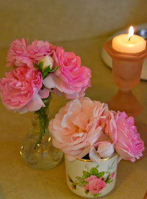 Rose bouquets from the garden in tiny tea cups and vases. Candles are always nice! 