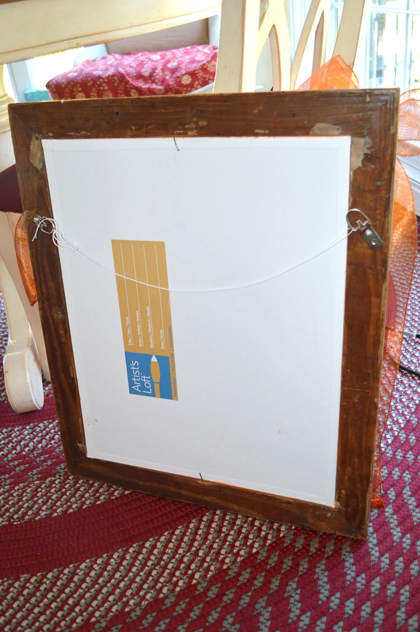 Back of picture frame with hooks and wire