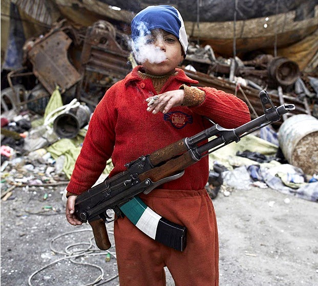 7 YEAR OLD SYRIAN REBEL - 29 Breathtaking Photographs of The Human Race