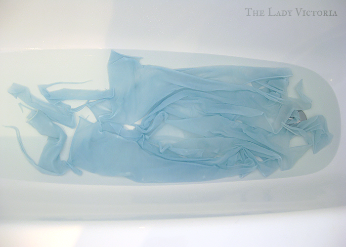 blue cotton knit fabric in a bathtub of bleach