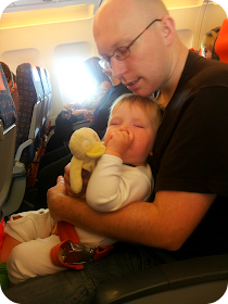 father and son asleep together, toddler on a plane
