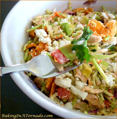 Spicy Broccoli Slaw and Chicken Salad, for lunch or for dinner on a hot summer night. Mix just a few ingredients together, refrigerate, let everyone choose their favorite toppings when you're ready to serve. | Recipe developed by www.BakingInATornado.com | #recipe #salad #chicken