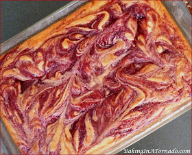 Raspberry Swirl Halloween Cake, a moist white raspberry swirled cake with fluffy vanilla frosting, decorated for Halloween | Recipe developed by www.BakingInATornado.com | #recipe #cake #Halloween