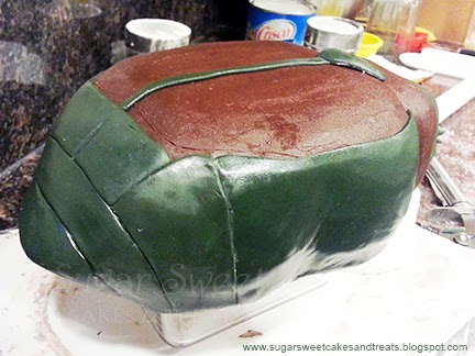 Adding green fondant to beetle cake for its body