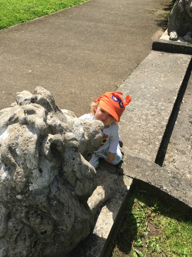 Piglet-Tigger-and-Pooh-toddler-greeting-stone-lion-at-Dyffryn-Gardens