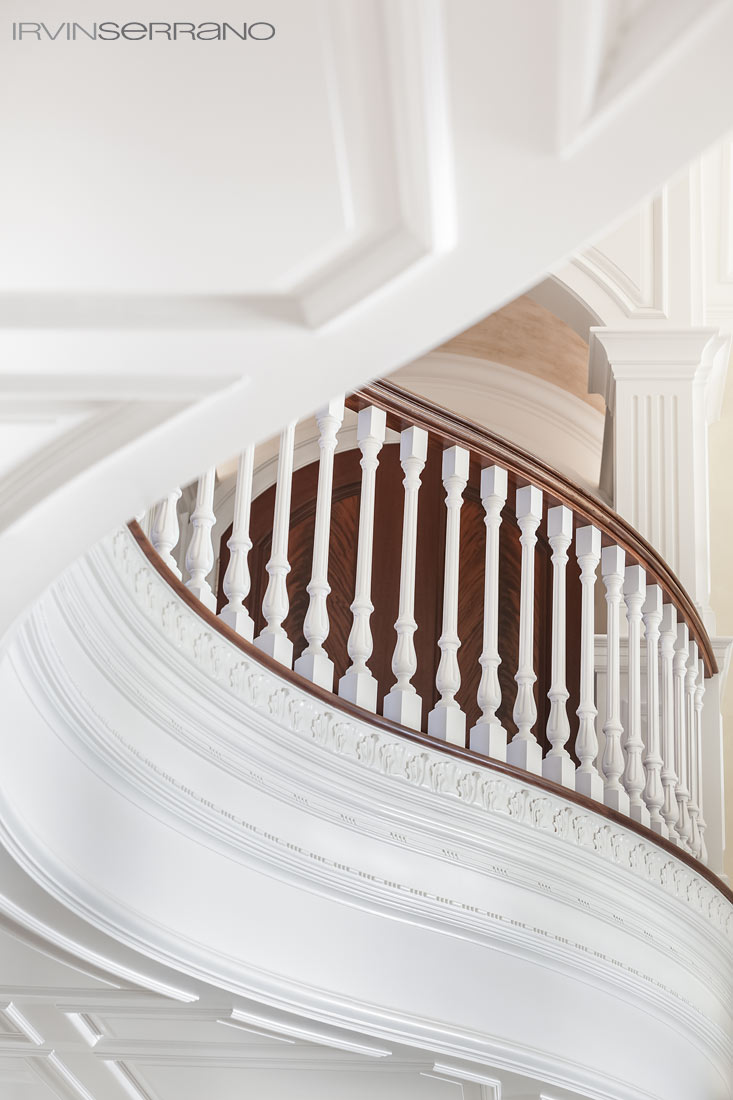 Detail view of the curve in the intricate molding, interior trim and paneling of a hallway, crafted by Tidewater Millwork, in a Southport estate in Maine.