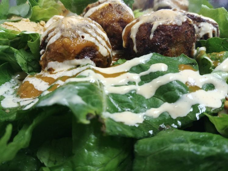 Falafel on a bed of greens at Peppy Olive