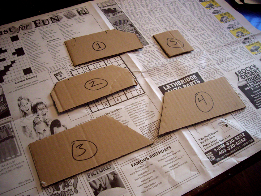5 cardboard bridge abutment templates numbered 1 through 5 laying on newsprint