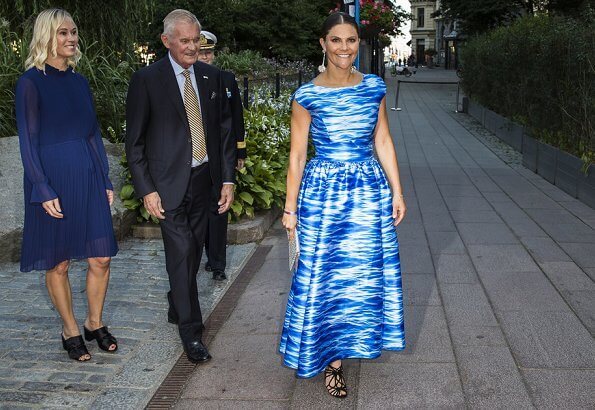 Crown Princess Victoria wore a Camilla Thulin sea blue print dress and carries Anya Hindmarch metallic clutch