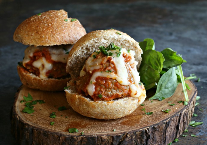 Beef and pork meatball sandwiches with tomato sauce and melted mozzarella cheese.