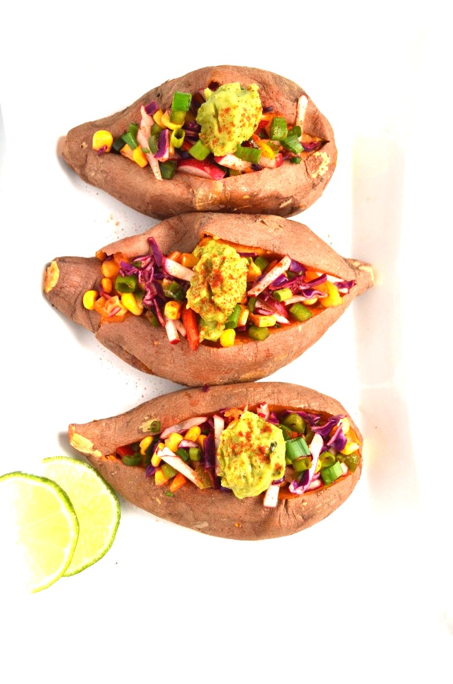 These Chipotle Stuffed Sweet Potatoes are fresh and full of flavor! They are packed full of vegetables and topped with flavorful guacamole. www.nutritionistreviews.com