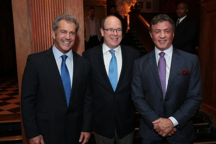 Prince Albert flanked by Mel Gibson and Sylvester Stallone at Tuesday's cocktail reception.