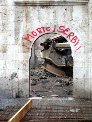 A call for ethnic cleansing in Kosovo at the gate of a destroyed church