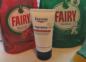 Eucerin Aquaphor Soothing Skin Balm on the kitchen windowsill with the washing up liquid