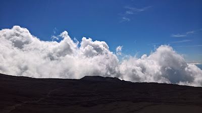 Clouds, lava and views from Mount Etna main crater.