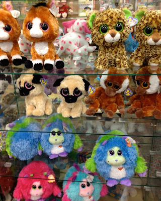 Shelves full of rounded, plush animals with huge round eyes