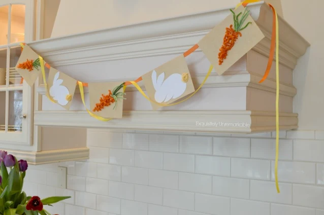 DIY Easter Garland hanging from a kitchen hood over a stove