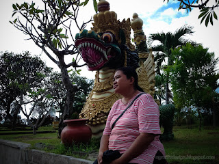 Traveler Woman In The Peaceful Garden With Big Dragon Statue At Buddhist Monastery North Bali Indonesia