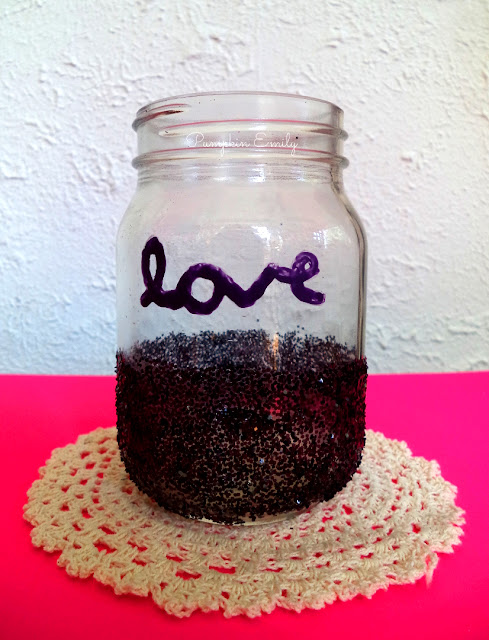 glitter jar that has a calligraphy on it and glitter on the bottom half of the jar